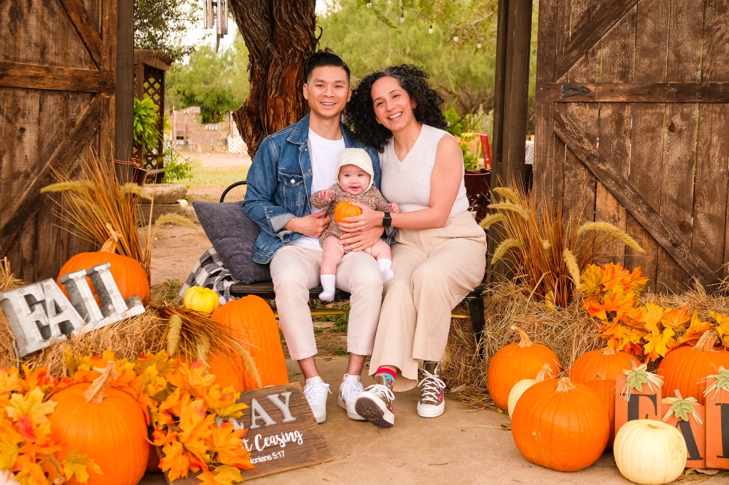 Young family posing with baby at Maddies Pumpkin Patch in McAllen, Texas. 
