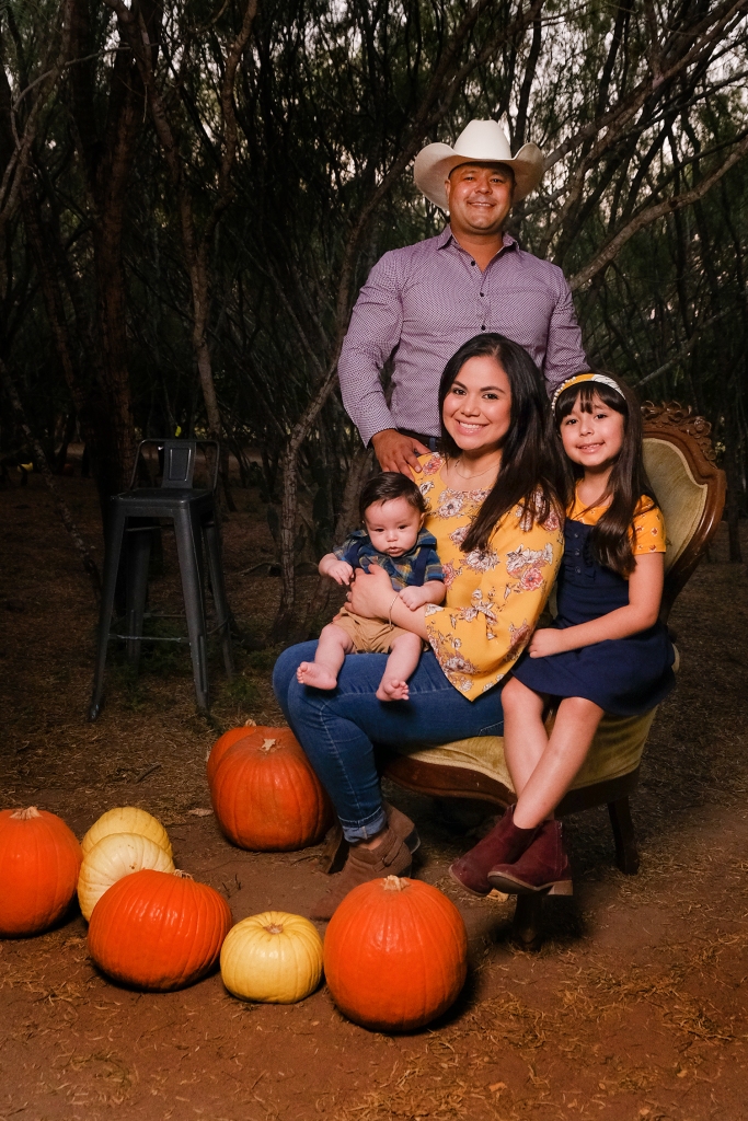 A family of four pose for a photo at Maddie's Pumpkin Patch in McAllen, Texas.